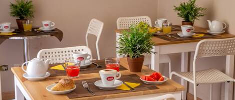 A breakfast setup with tables, chairs, and breakfast items.