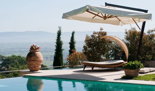 Outdoor pool, open 9:00 AM to 7 PM, pool umbrellas, pool loungers