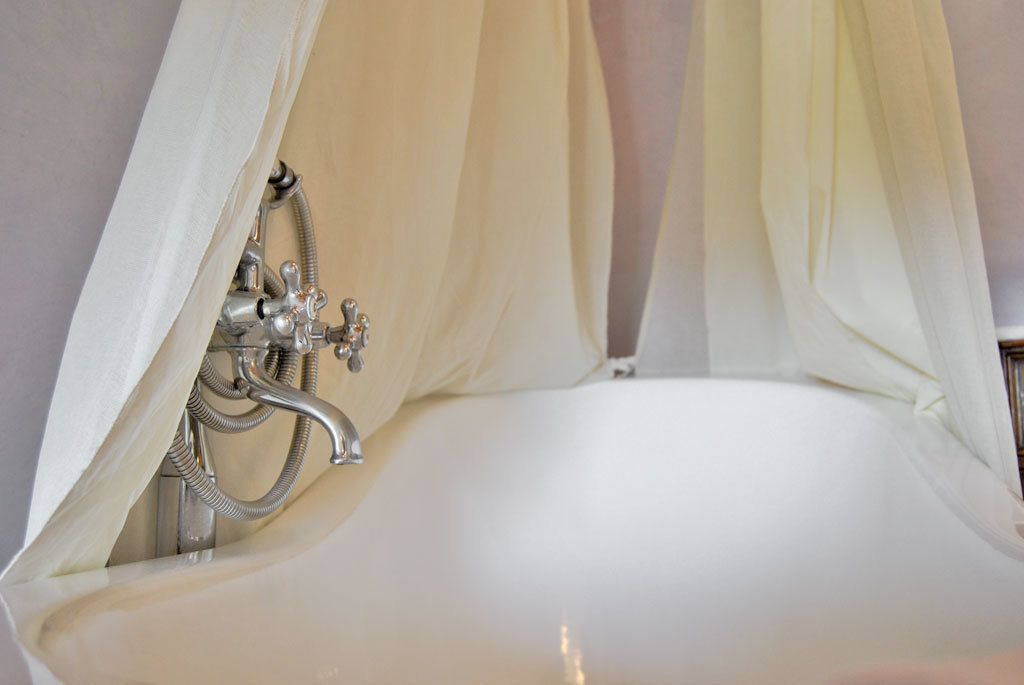 A bathroom with a white sink and a shower curtain.