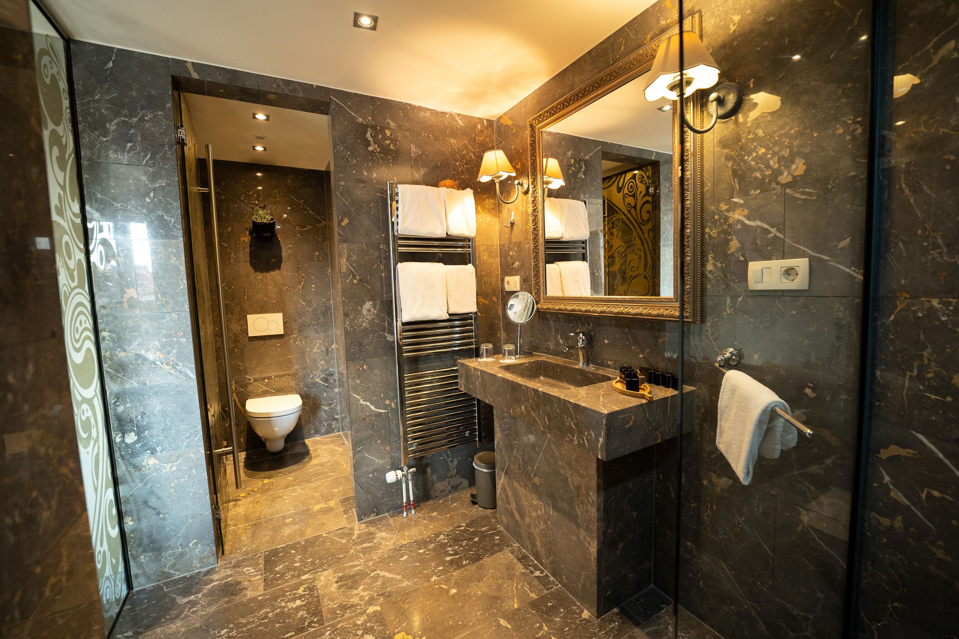 one-bedroom suite with balcony and city view | bathroom | free toiletries, hair dryer, bathrobes, slippers