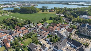 Vista aérea de una zona residencial con casas, una iglesia y un campo abierto extenso.