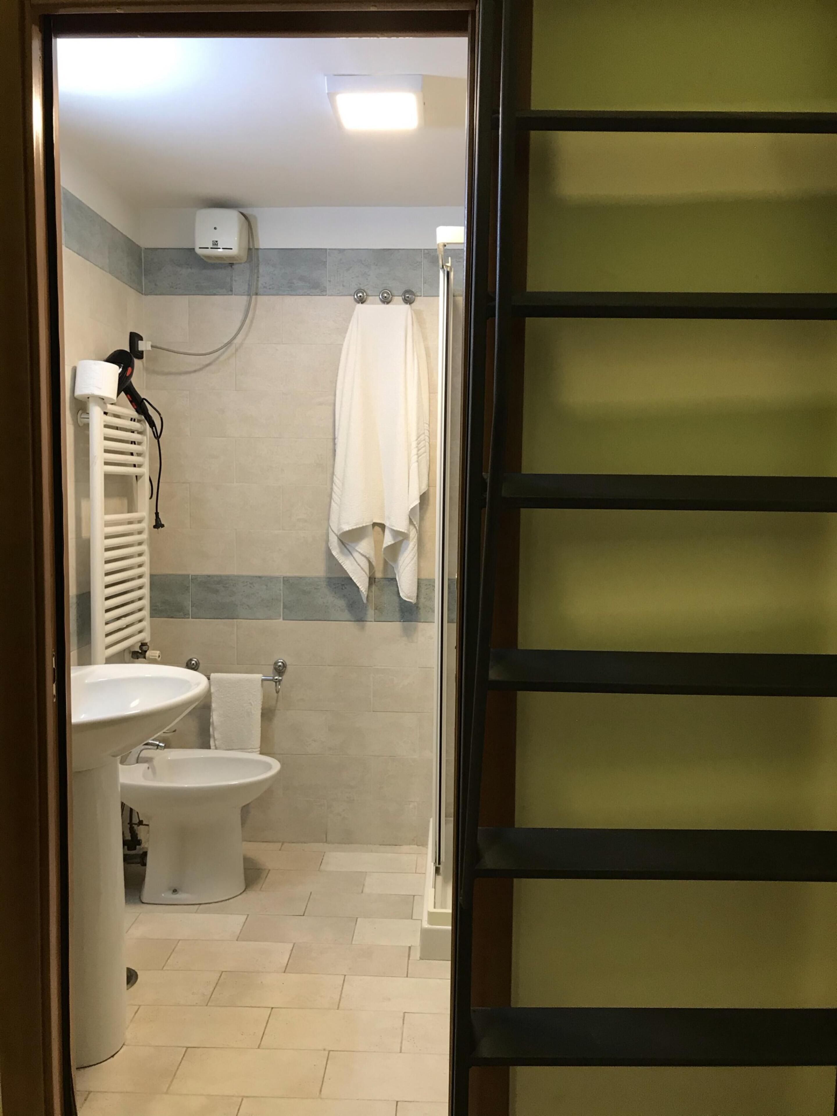 A bathroom with a sink, toilet, and shower.