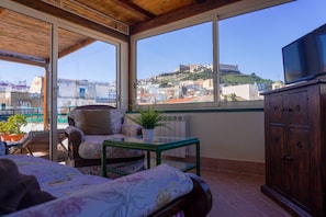 Superior Suite, City View | Living area | TV