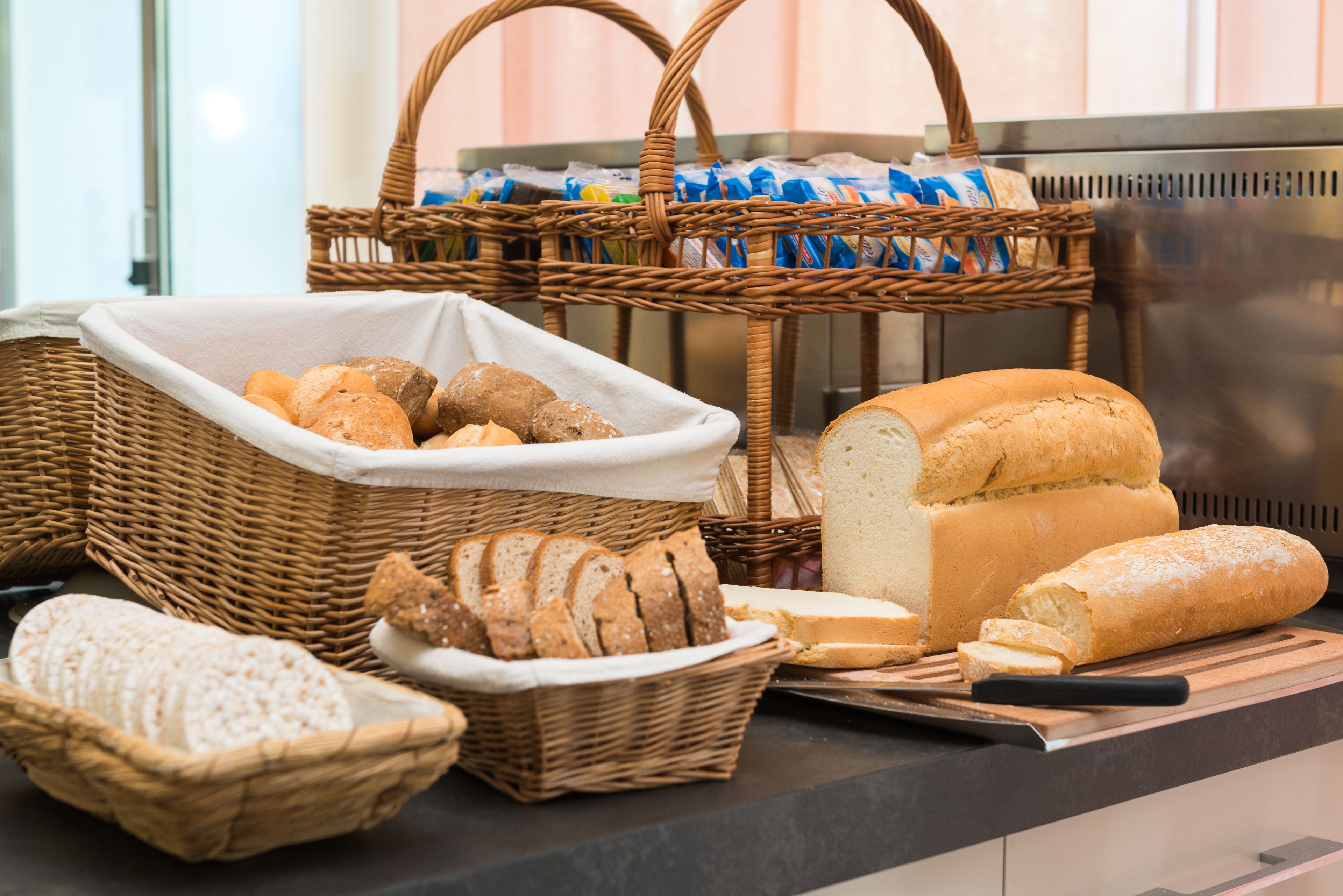 A variety of breads and pastries displayed on a counter.