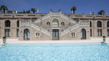 Seasonal outdoor pool, open 9:00 AM to 9:00 PM, pool umbrellas