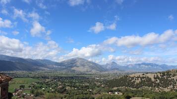 A mountainous landscape with a village in the valley.