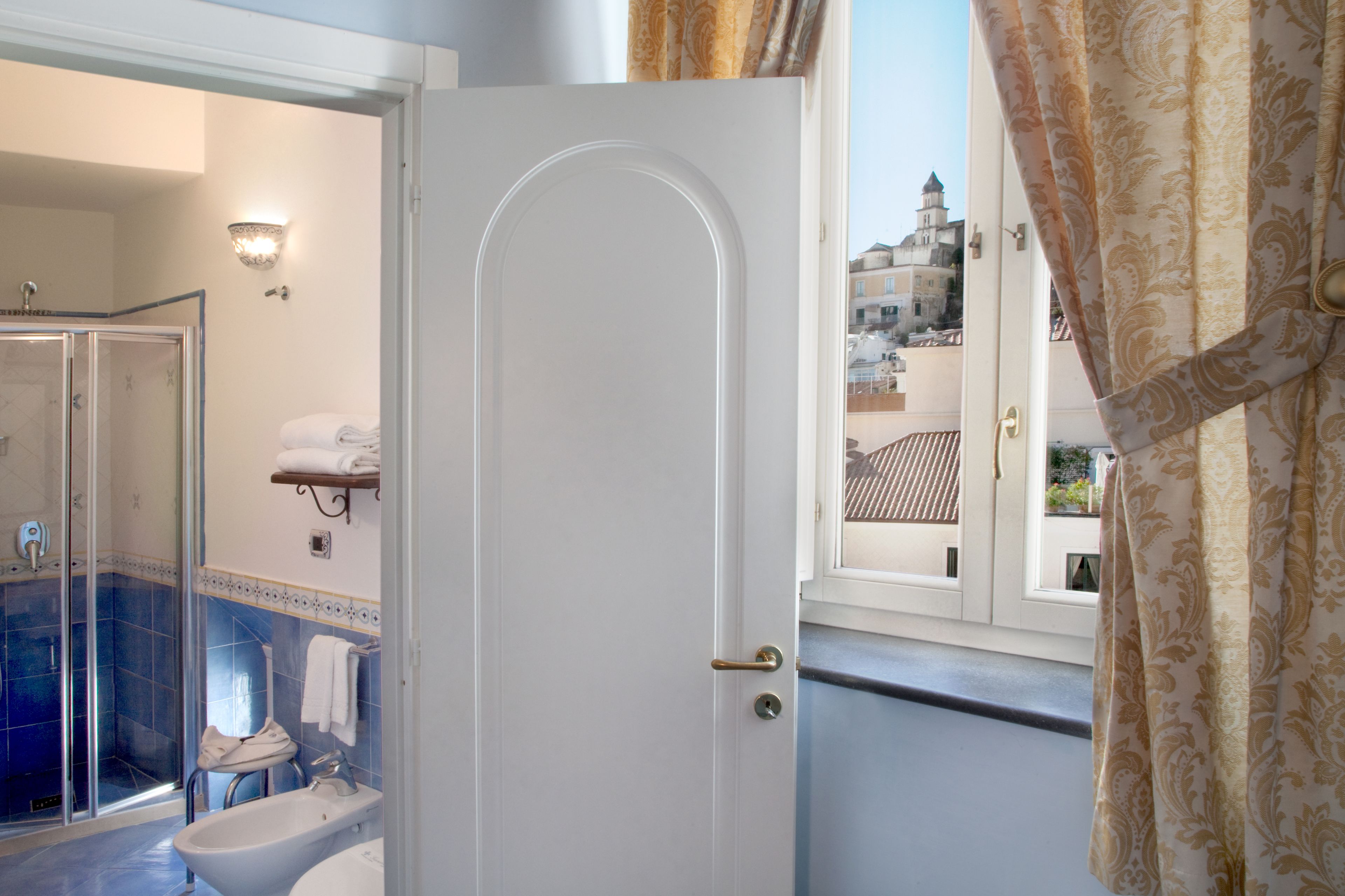 junior studio suite | bathroom | shower, rainfall showerhead, hair dryer, slippers