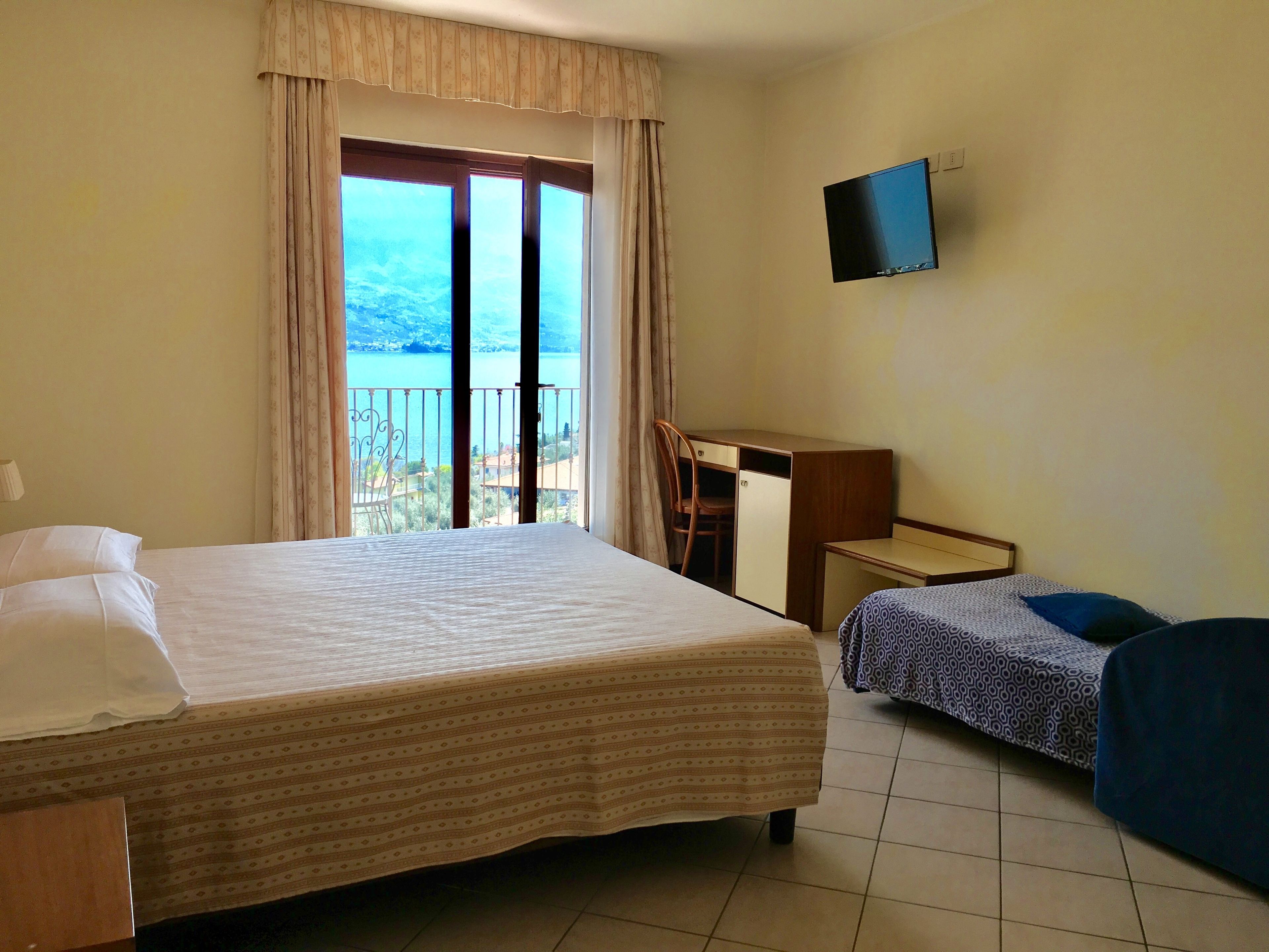 triple room, lake view | minibar, in-room safe, desk, blackout curtains