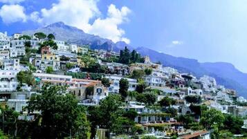 A coastal town with buildings built on a hillside, overlooking the sea.