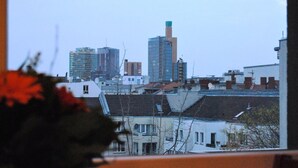 A cityscape with various buildings, including a prominent tall structure with a green top. - Pension ABC (Berlin)