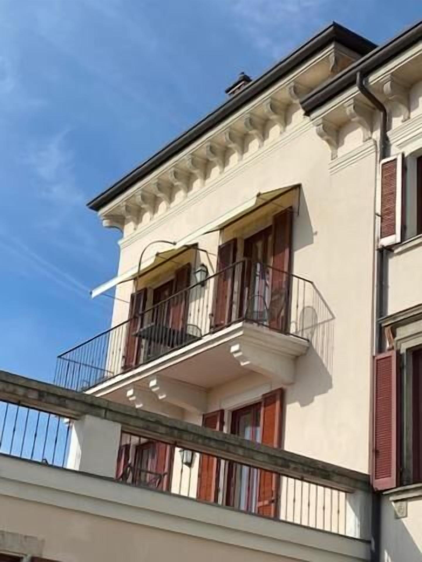 A multi-story building with a balcony on the second floor.