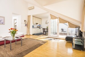 Apartment, 1 Bedroom, Terrace (4 people - under the roof) | Living area | Flat-screen TV - Appartements Ferchergasse (Vienna)