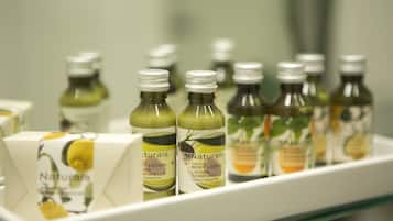 A shelf with multiple bottles of lotion and a box of soap.