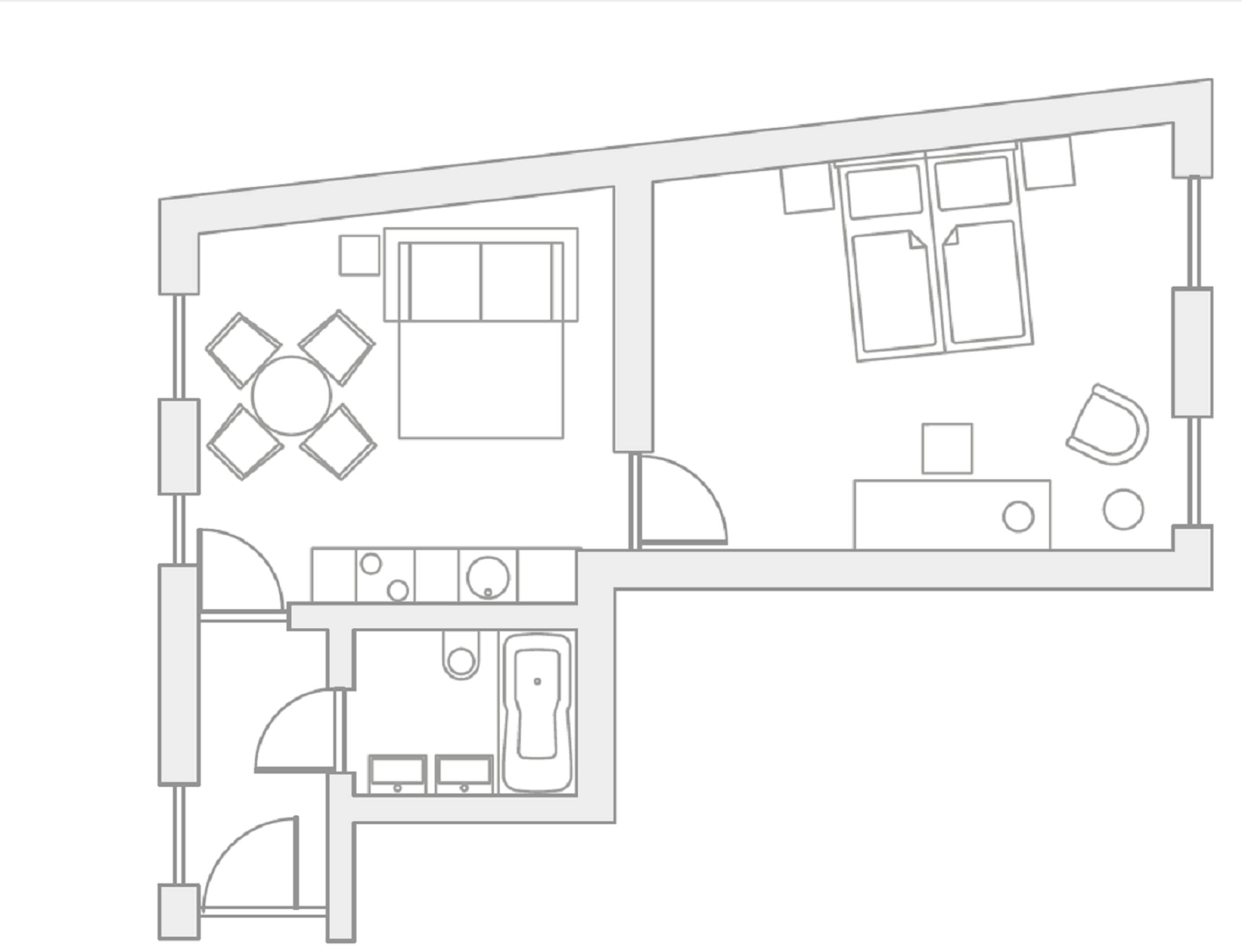 Plano de un cuarto de hotel que incluye una cama, un escritorio, una silla, un baño pequeño y un área de comedor con mesa y sillas.