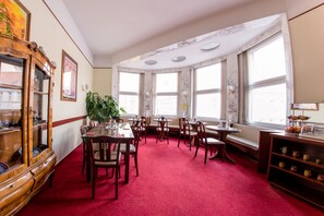 A room with a red carpet, wooden furniture, a large mirror, and a window with a view. - Hotel Pension Dormium (Vienna)