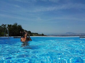 Seasonal outdoor pool, pool umbrellas, pool loungers