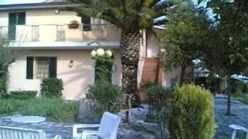 Guests can enjoy a balcony with potted plants and a seating area with two chairs and a table.