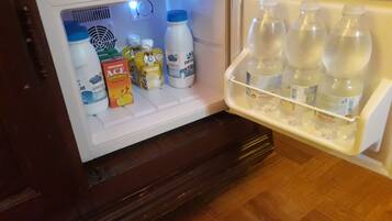 A refrigerator with various beverages and food items inside.