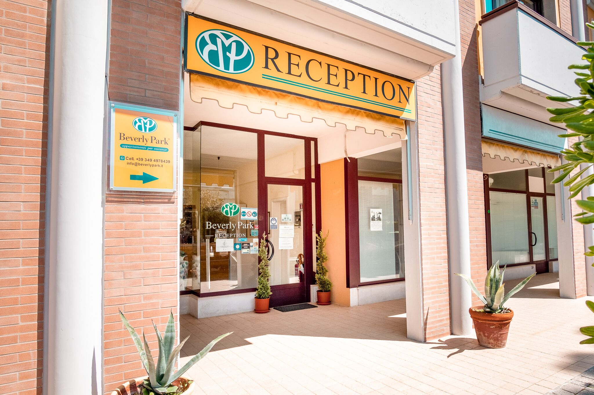 A reception area with a sign indicating 'Beverly Park' and a directional arrow.