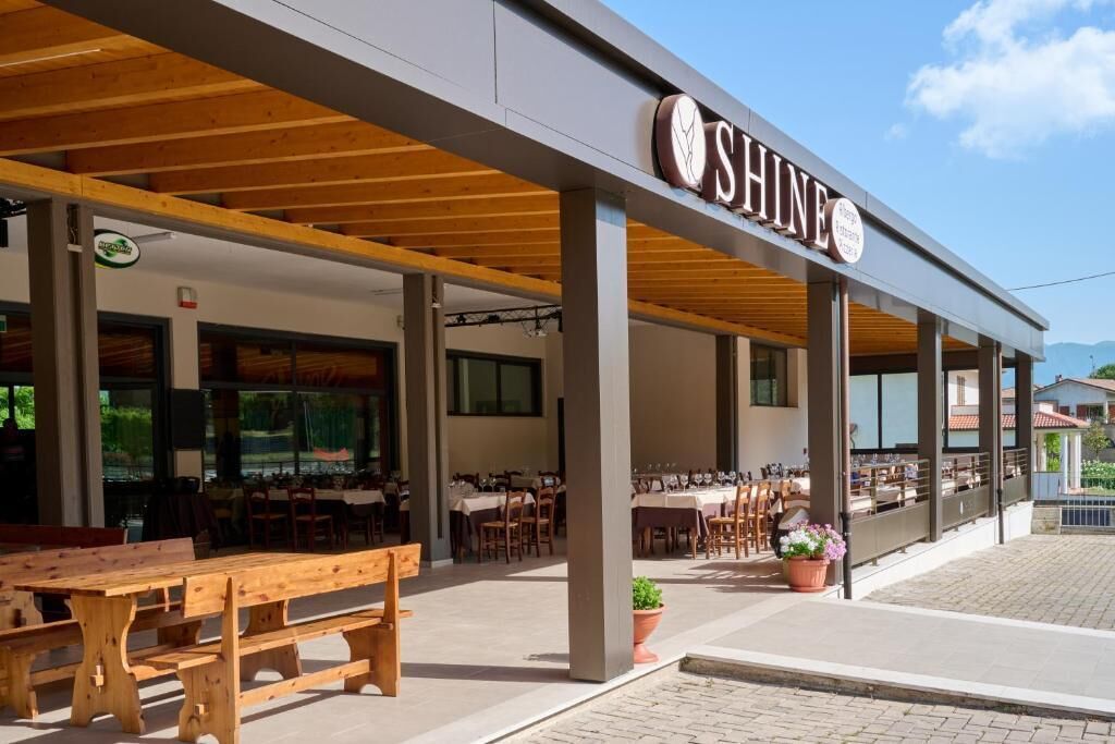 A restaurant named SHINE with outdoor seating and a covered patio area.