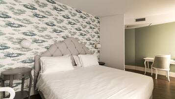 A neatly arranged bedroom with a bed, bedside tables, and a chair.