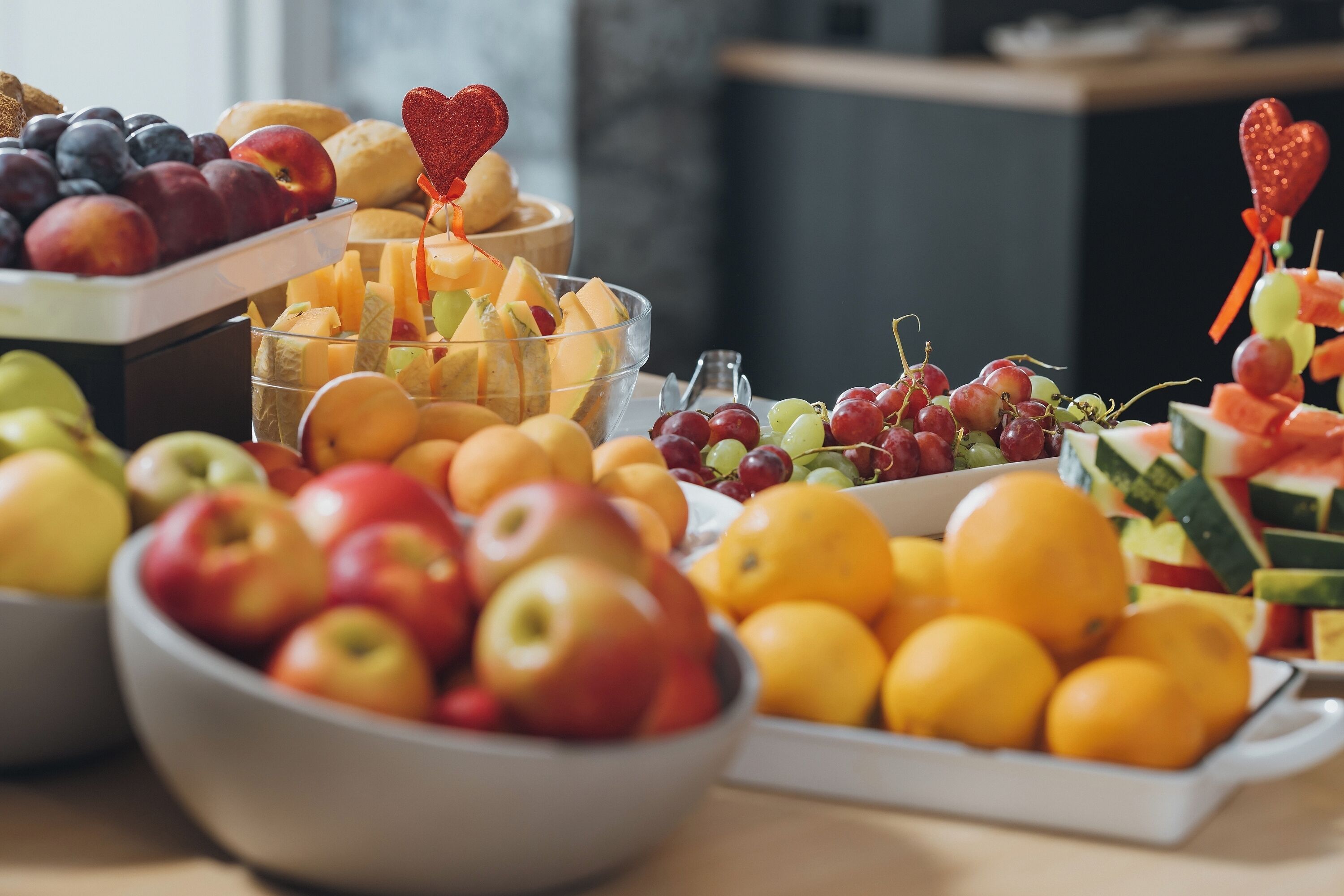 A table with various fruits and a heart-shaped decoration.