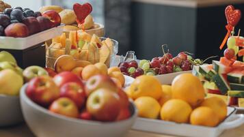 A table with various fruits and a heart-shaped decoration.