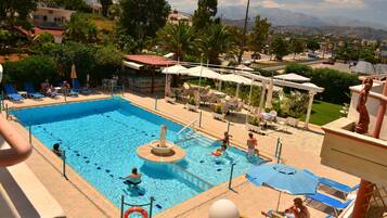 Seasonal outdoor pool, open 8:30 AM to 9 PM, pool umbrellas