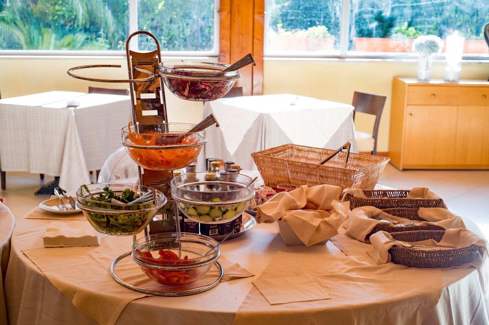 A buffet table with various food items and condiments.