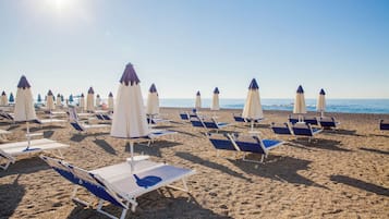 Private beach, black sand, sun-loungers, beach umbrellas