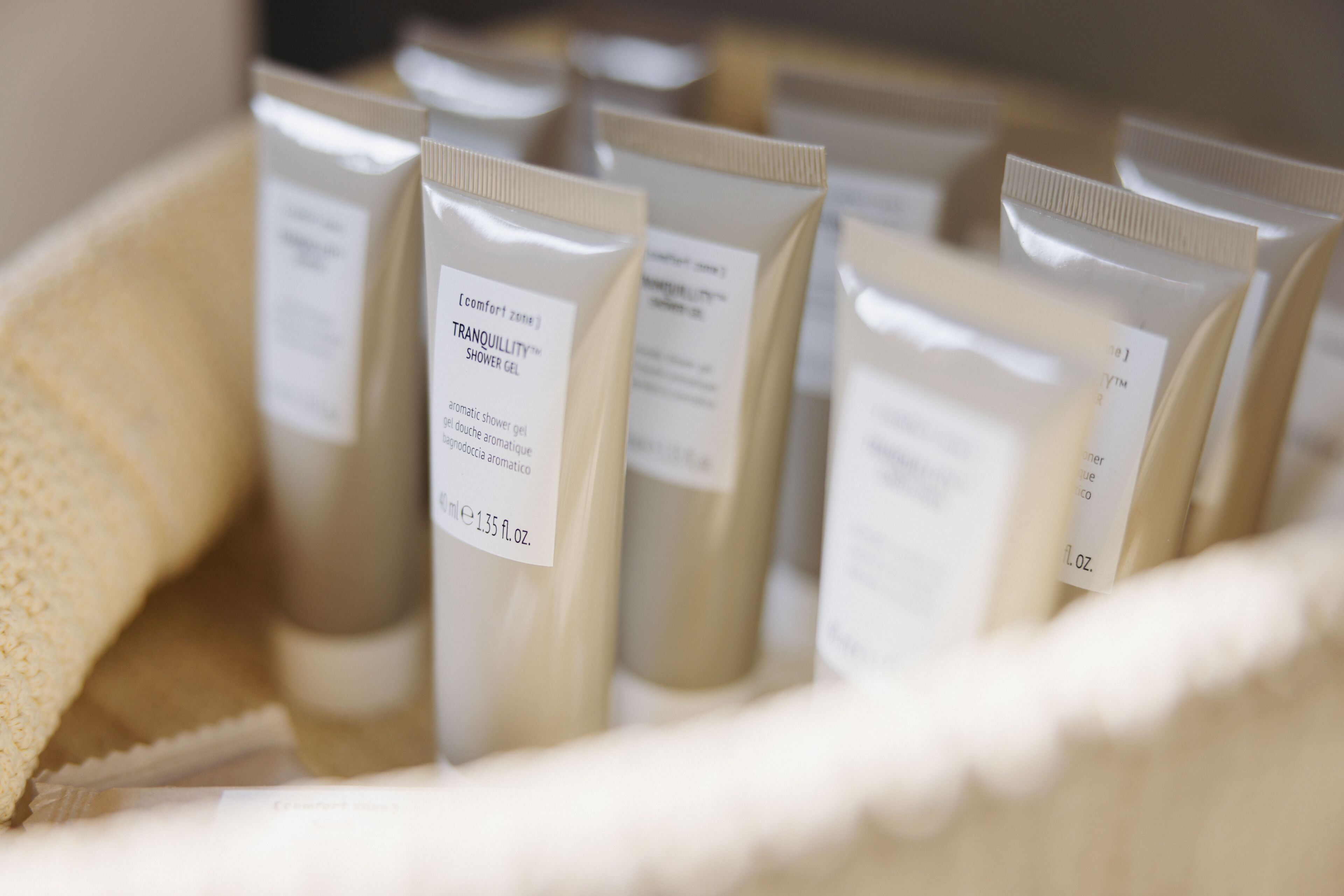 En uppsättning hygienartiklar i en beige behållare.