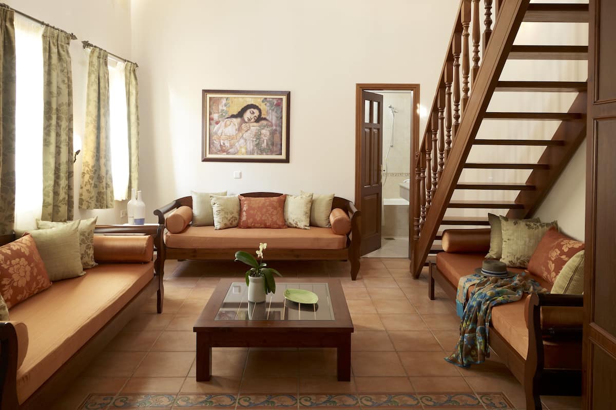 Ein Wohnzimmer mit einer Couch, einem Couchtisch und einer Treppe.