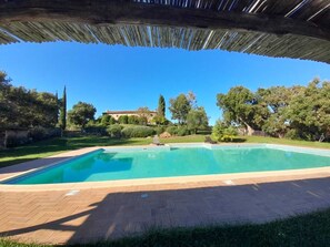 A swimming pool with a tiled deck, surrounded by a garden and trees. - Tenuta di Seripa (Sassetta)