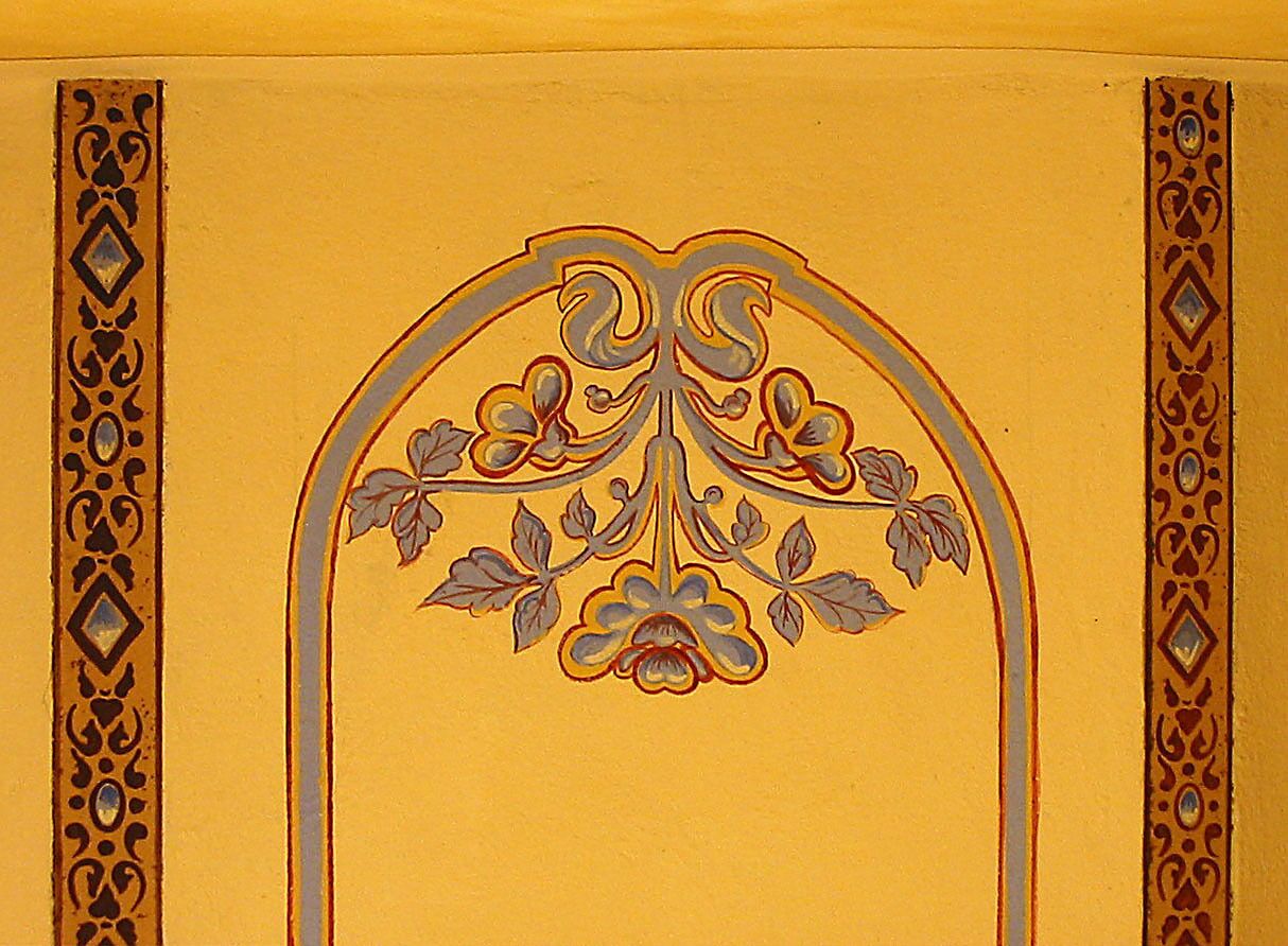 A decorative panel with an ornate floral design, framed by a symmetrical border.