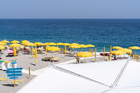 Private beach, white sand, sun loungers, beach umbrellas