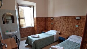 A room with two beds, a sink, and a mirror. - Cressy (Rome)
