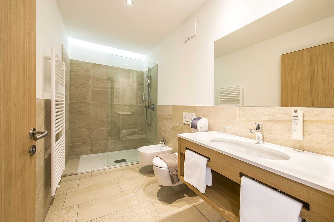 shower, hair dryer, slippers, towels