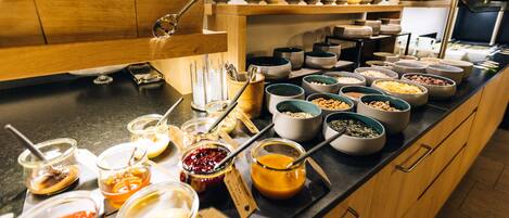 A buffet with various food items and condiments.