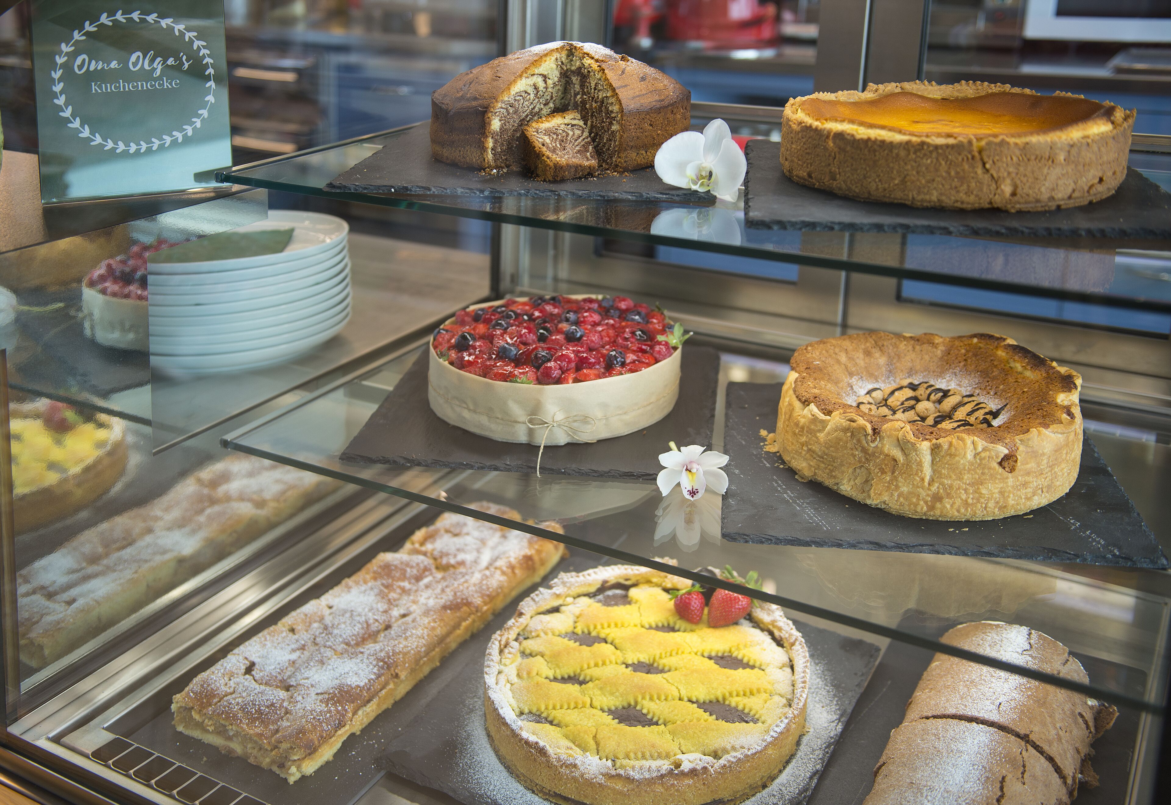 A bakery display case with various cakes and pastries.