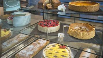 A bakery display case with various cakes and pastries.