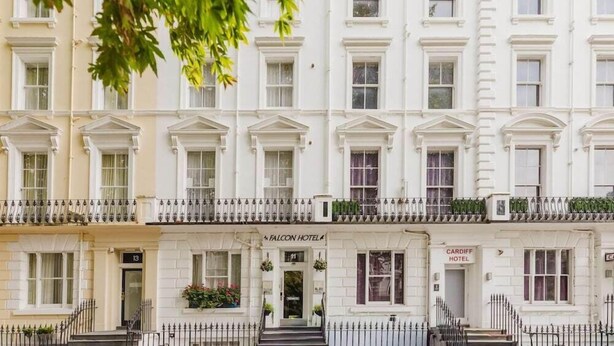 A row of white buildings with balconies, including the Falcon Hotel and Cardiff Hotel. - Falcon Hotel (London)