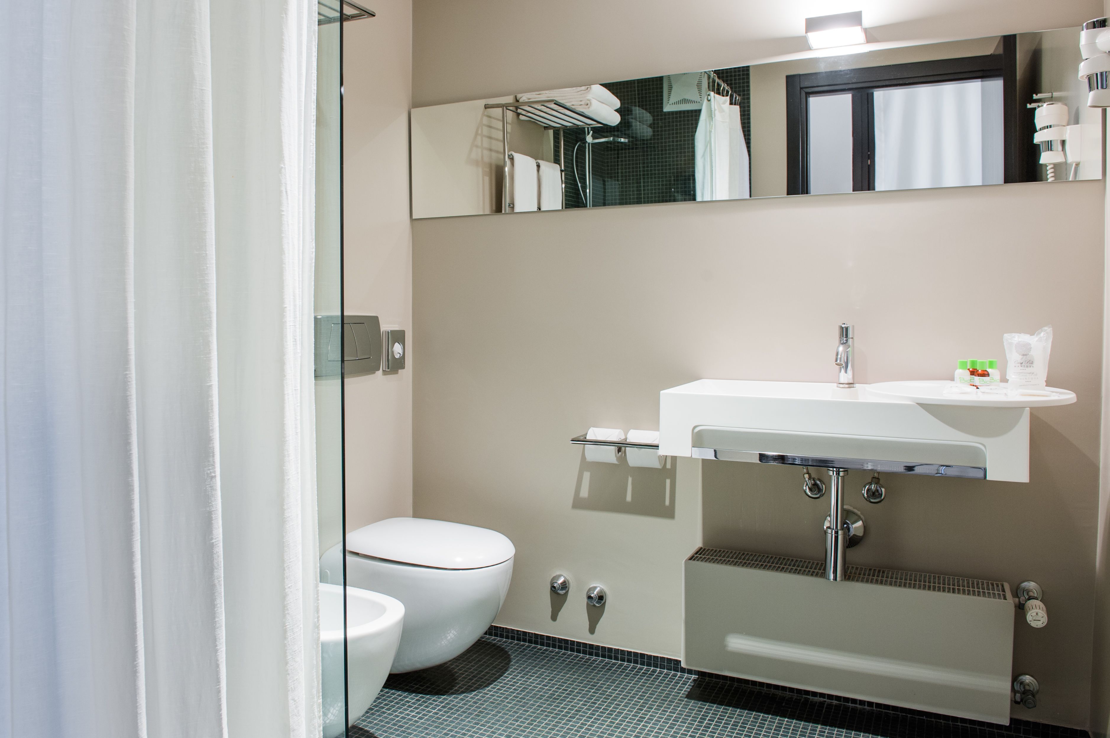 deep-soaking bathtub, rainfall showerhead, free toiletries, hair dryer