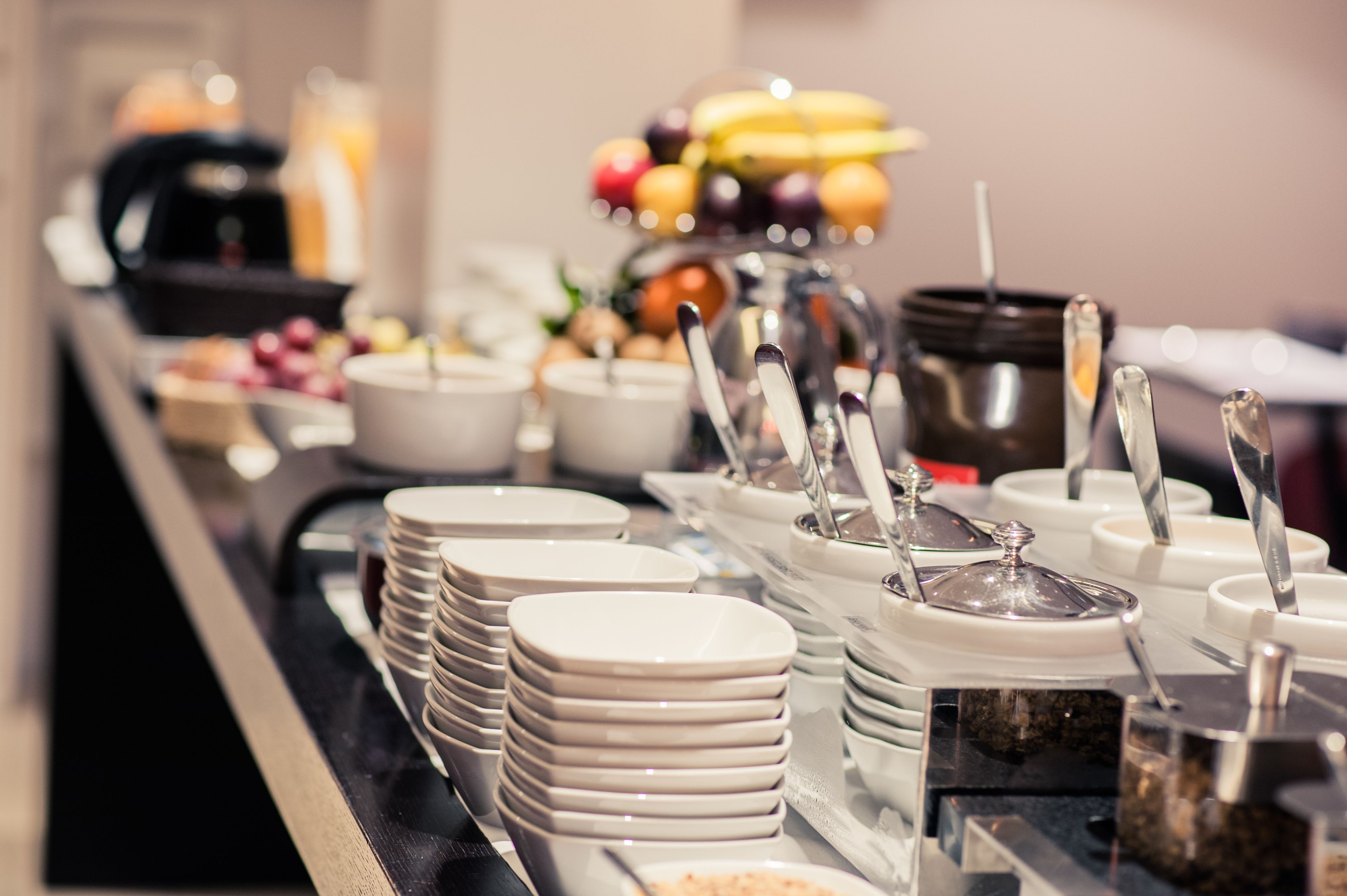 A buffet setup with various food items and utensils.