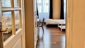 A room with a bed, a chair, and a desk. - Residence Casa Italia  (Prague)