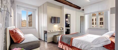 A modern hotel room with a bed, a desk, a TV, and a window with a city view.