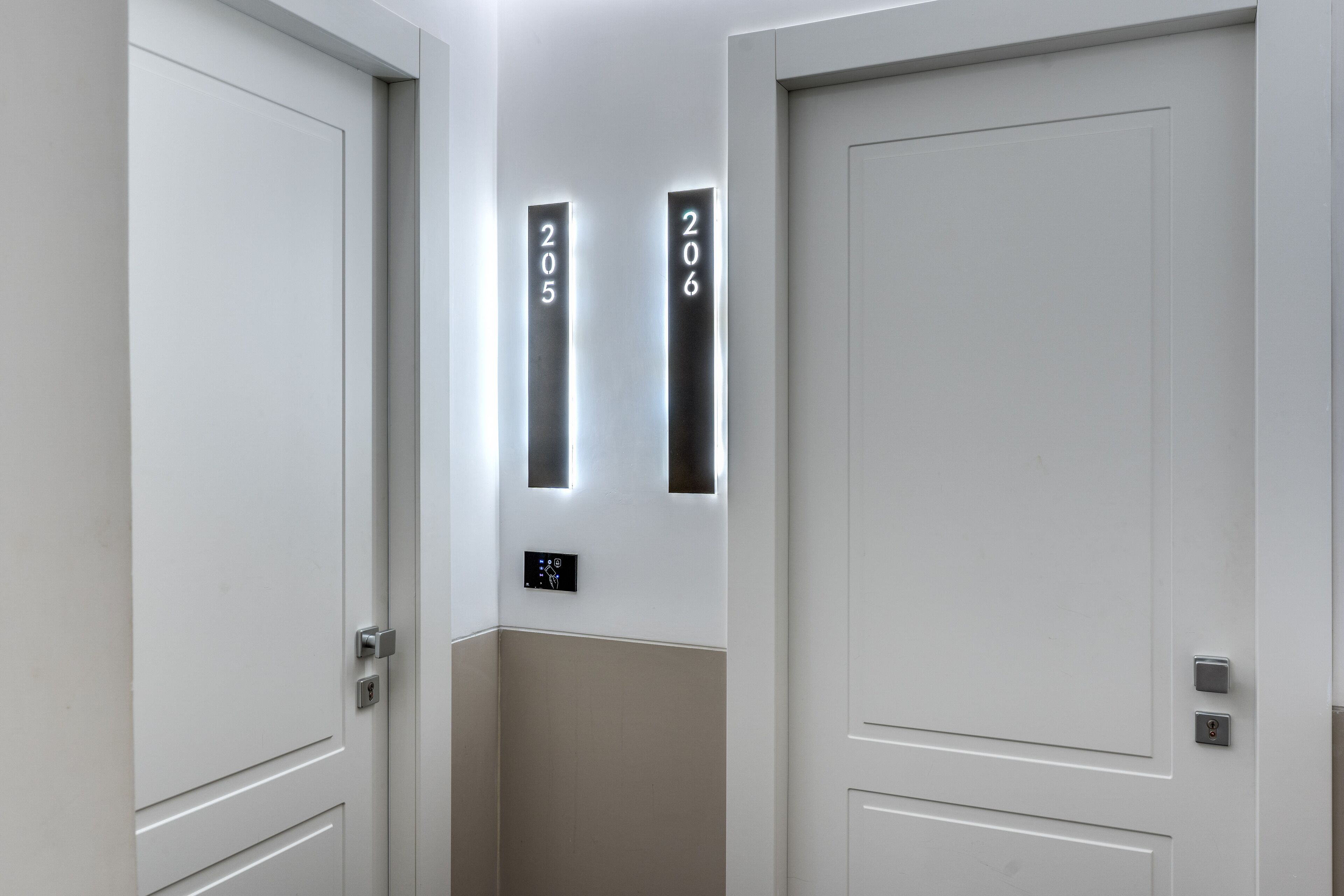 A hallway with two doors, each marked with a number.