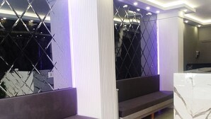 A modern lobby with marble flooring, a seating area with sofas, and a decorative wall with geometric patterns. - Star Hotel Istanbul - Special Class (Istanbul)