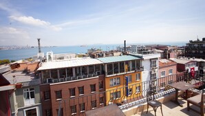 A multi-story building with balconies overlooking a waterfront. - Star Hotel Istanbul - Special Class (Istanbul)