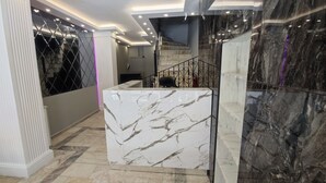 A modern lobby with marble flooring, a reception desk, and a staircase. - Star Hotel Istanbul - Special Class (Istanbul)