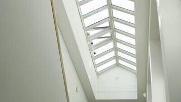 Eine Wendeltreppe mit Oberlicht, die zu einer oberen Etage führt.